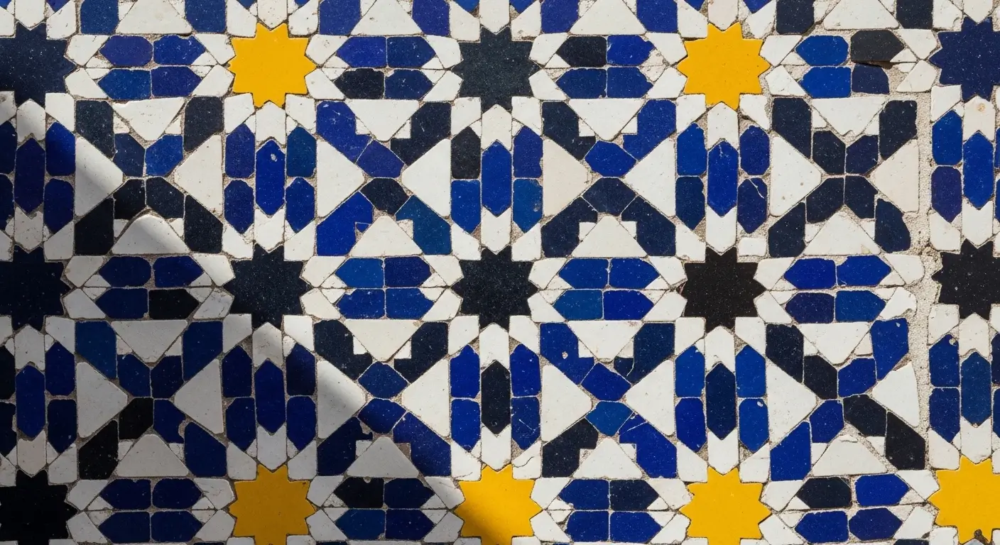 Moroccan Mosaic Art - Close-up of authentic Moroccan zellige mosaic tiles in cobalt blue and saffron geometric star pattern, Fes medina
